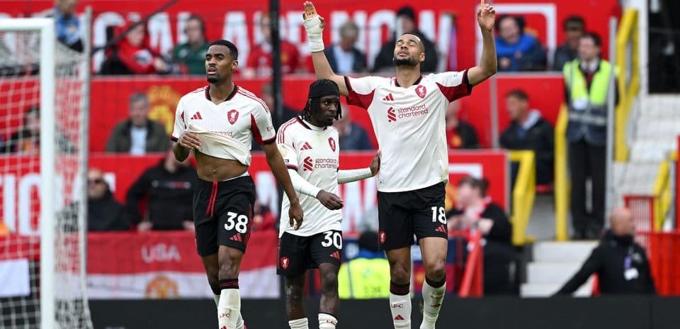 Three players celebrating on the field after match