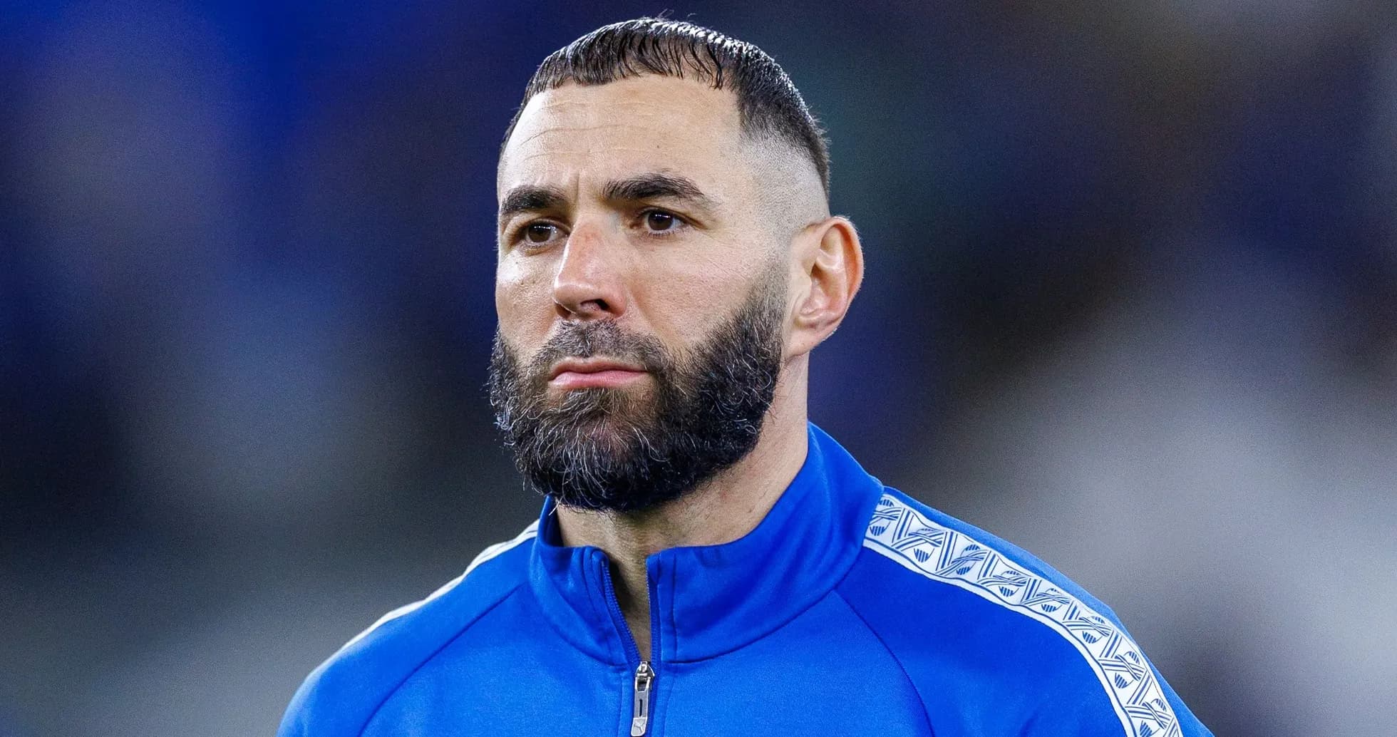 Player in blue tracksuit during pre-match preparation