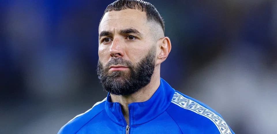 Player in blue tracksuit during pre-match preparation