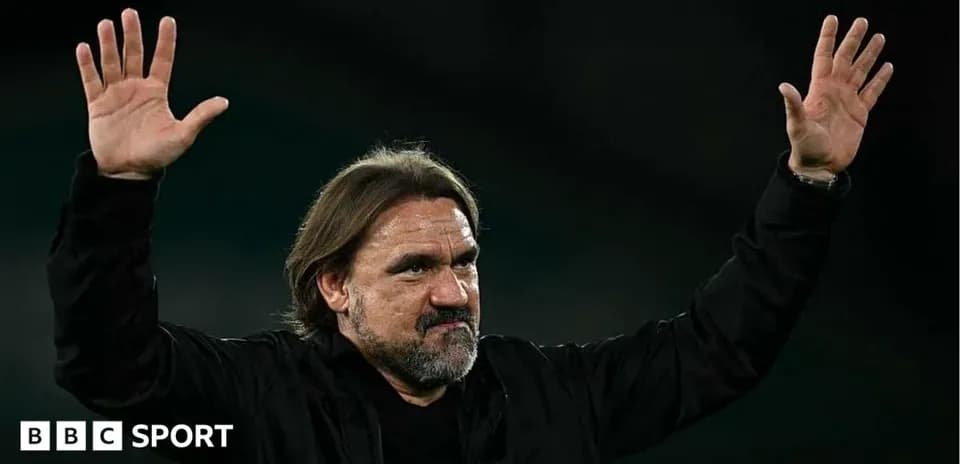 Coach waving to fans during post-match celebration