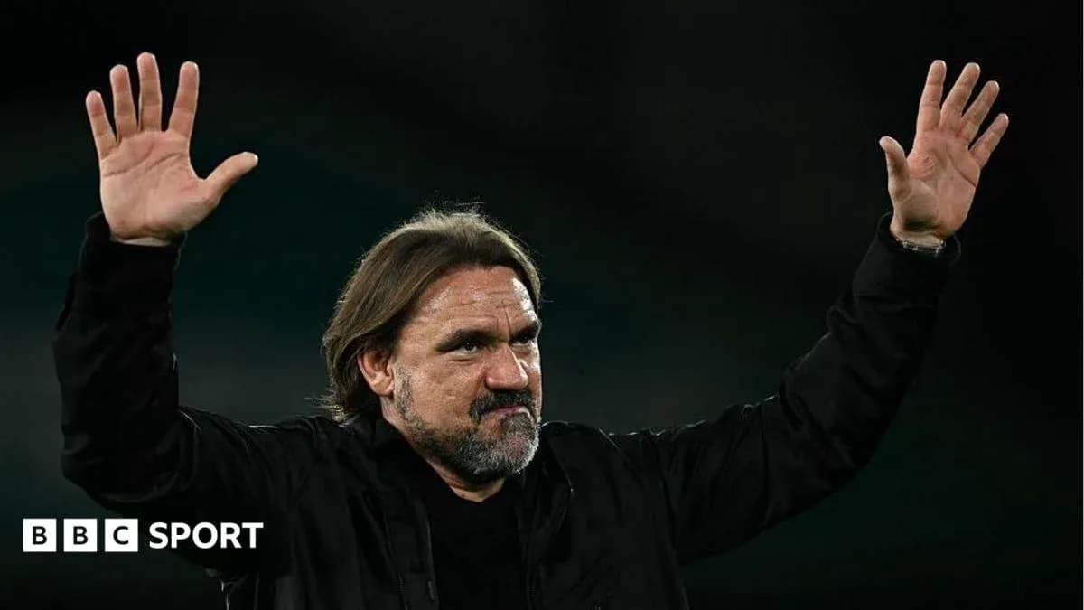 Coach waving to fans during post-match celebration