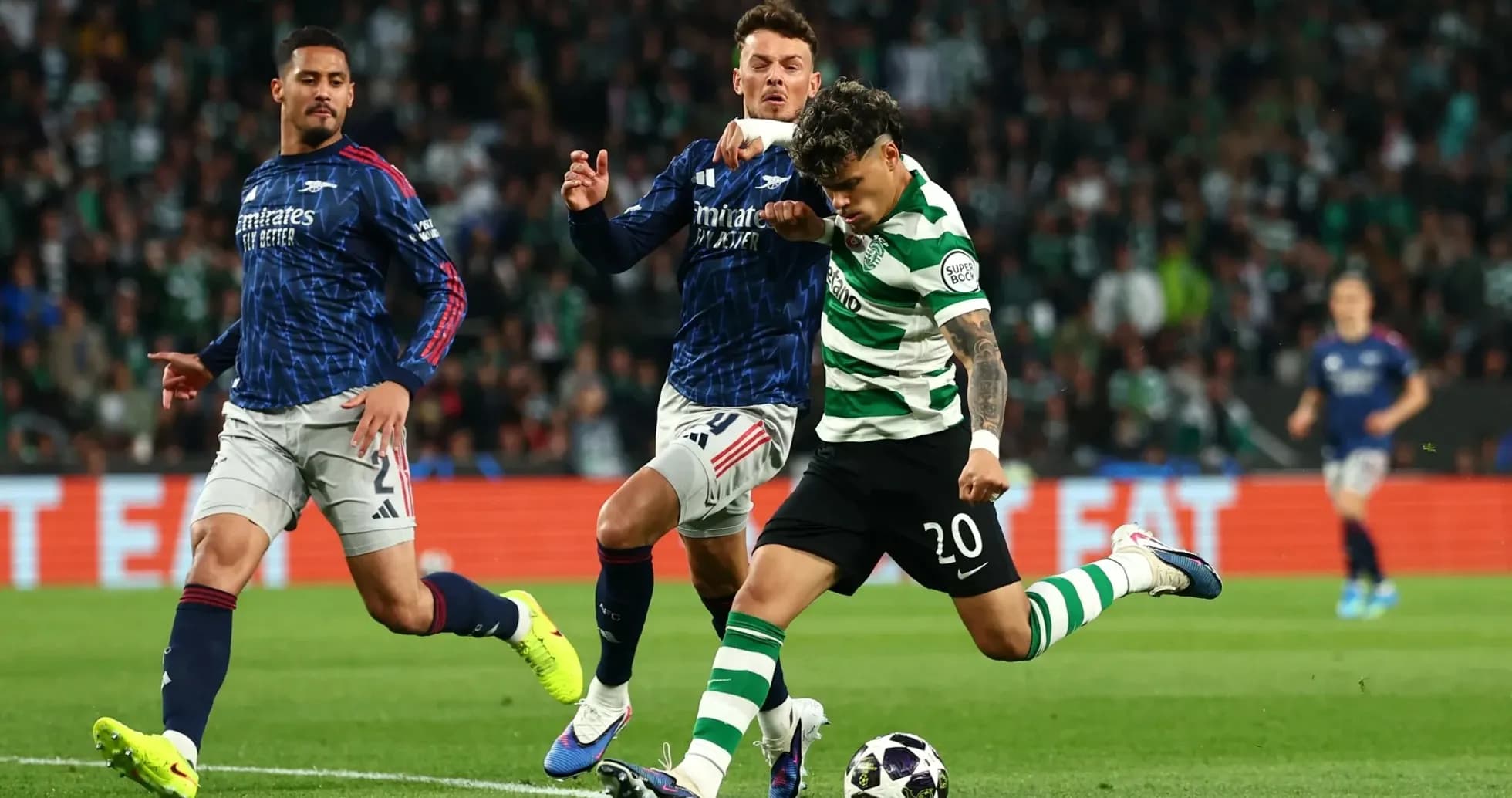 Player in green and white stripes kicking ball during match