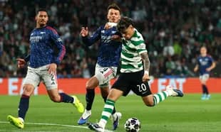 Player in green and white stripes kicking ball during match