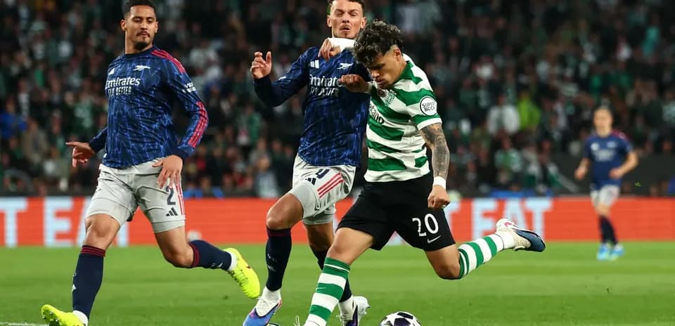 Player in green and white stripes kicking ball during match