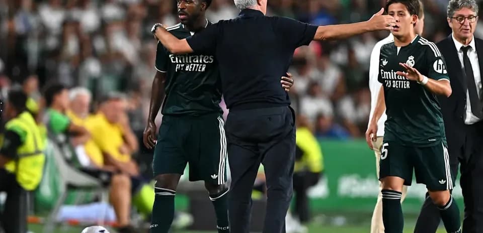 Coach discussing strategy with players during match