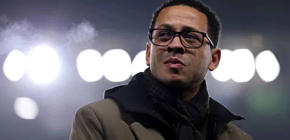 Person in glasses with stadium lights in background