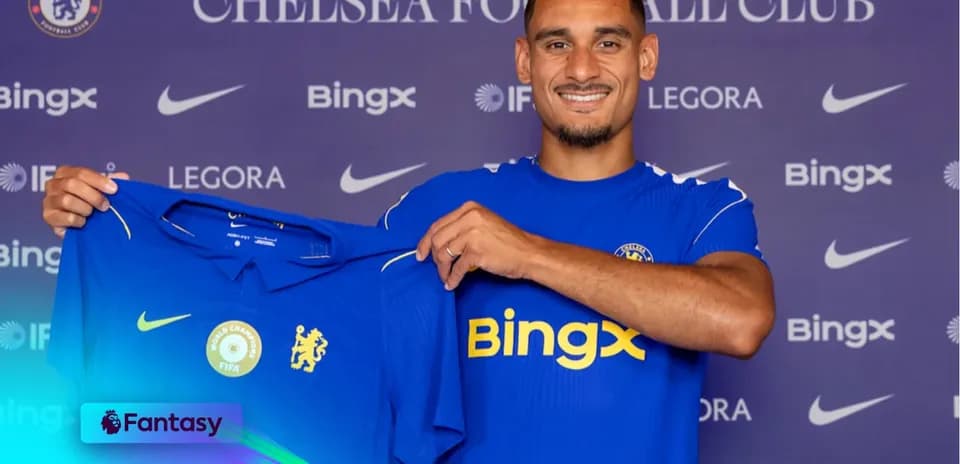 Player holding Chelsea FC jersey at presentation event
