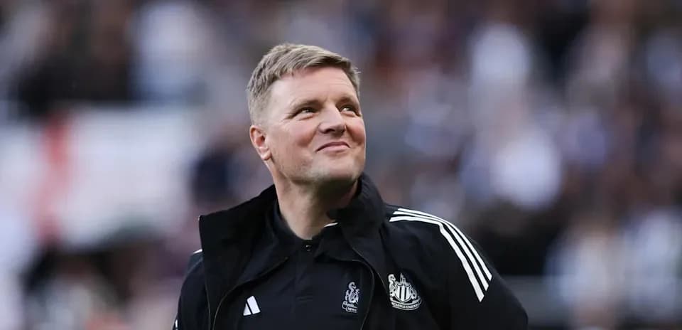 Newcastle United manager smiling on the sidelines