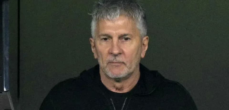 Man with gray hair wearing a black jacket