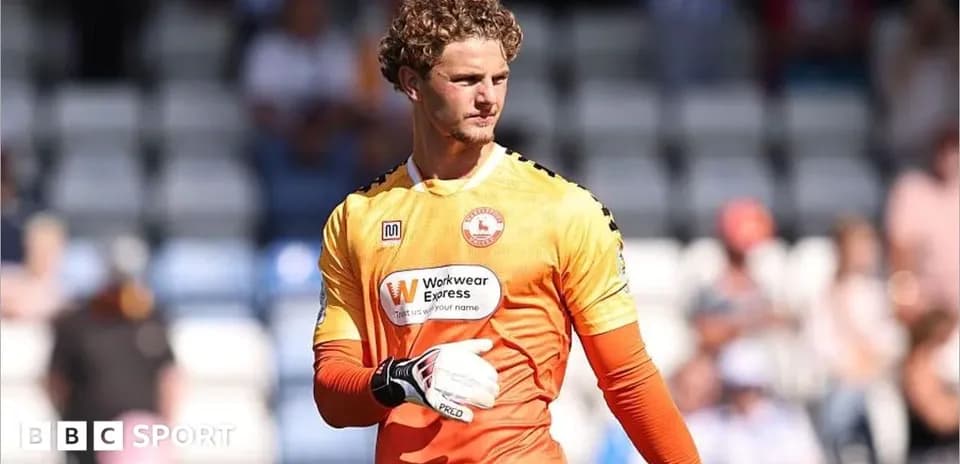 Goalkeeper in orange kit preparing for match