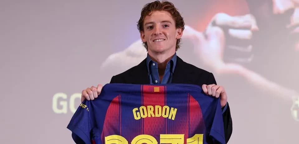 Player holding FC Barcelona jersey during presentation