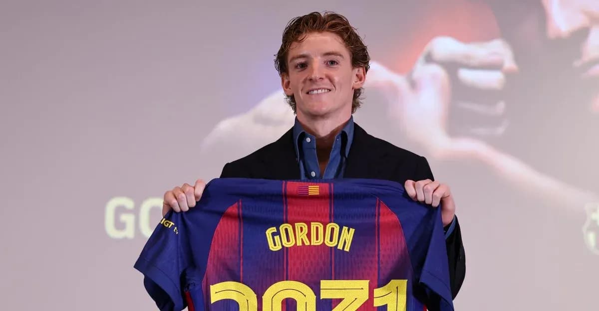 Player holding FC Barcelona jersey during presentation