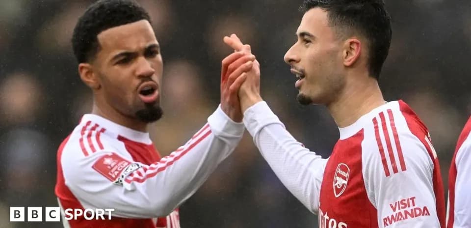 Two Arsenal players celebrating a goal together