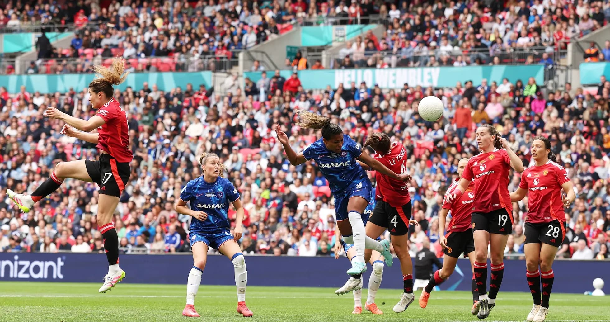 Players competing for the ball in FA WSL match