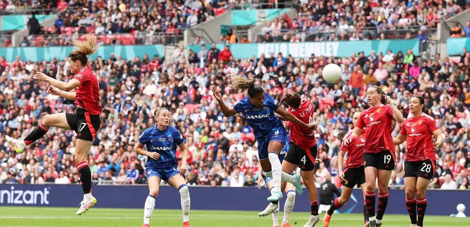 Players competing for the ball in FA WSL match