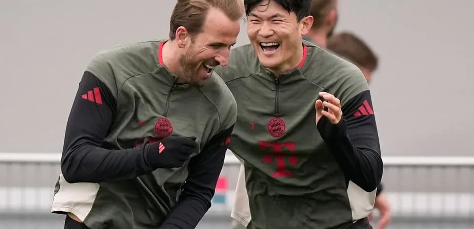 Two Bayern Munich players laughing during training session