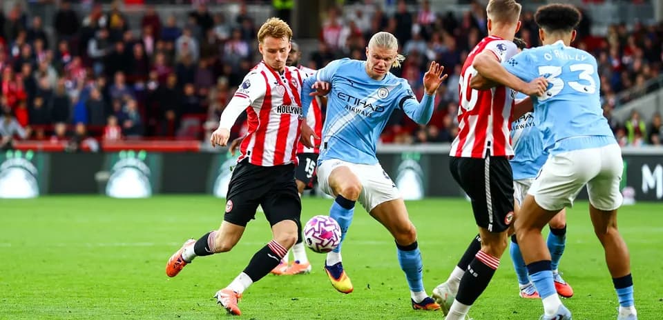 Manchester City players contesting a ball against Brentford