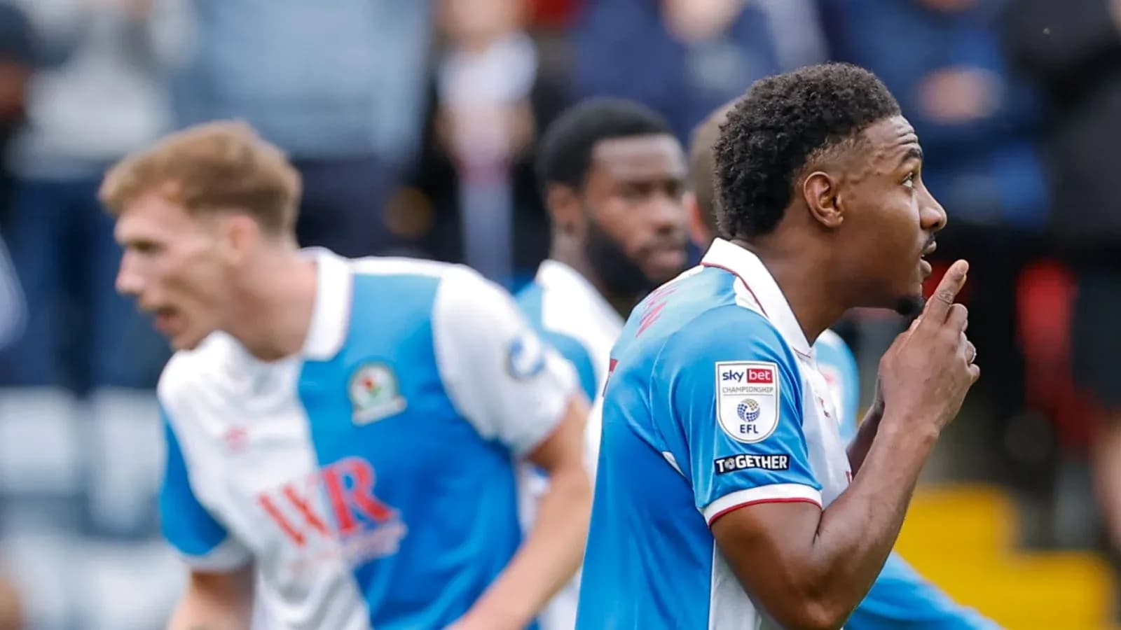 Player celebrating a goal with a shushing gesture
