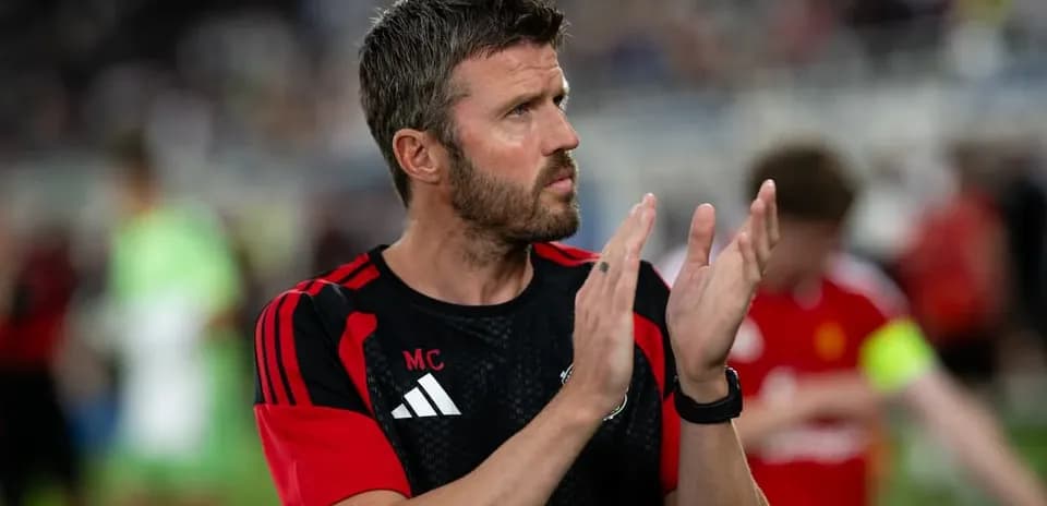 Coach applauding players after the match