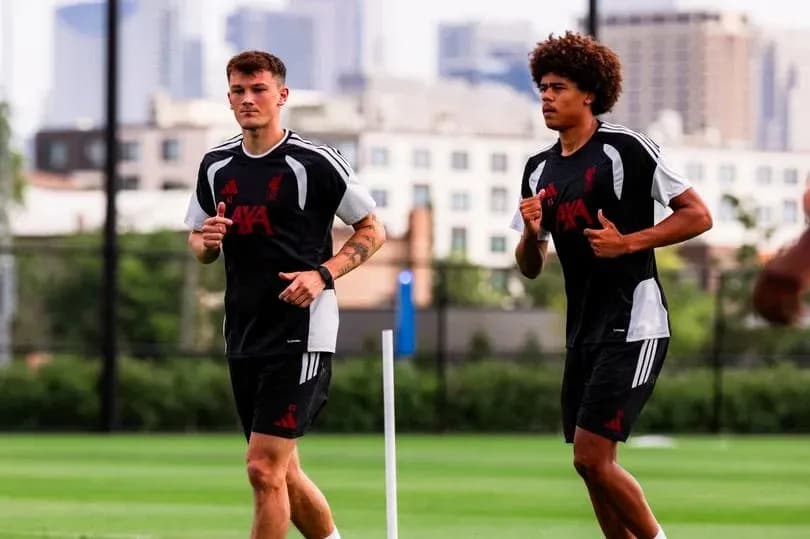 Two players jogging during training session on pitch
