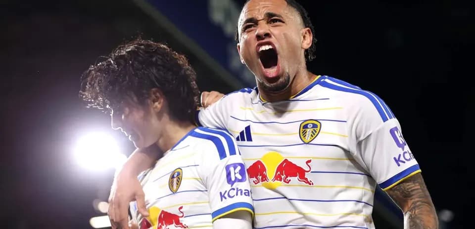 Two Leeds United players celebrating on the pitch