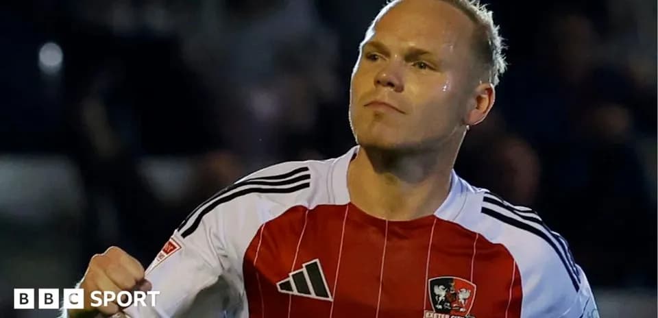 Player celebrating a goal in Exeter City FC jersey