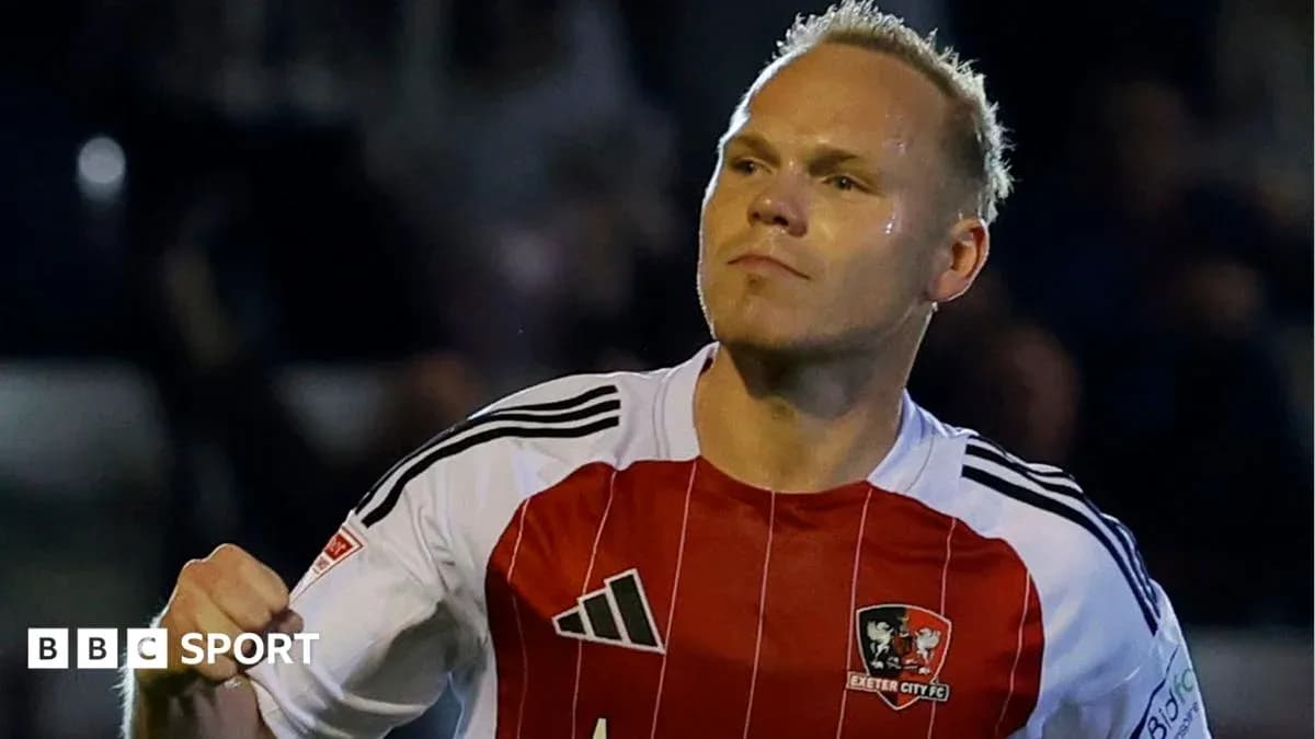 Player celebrating a goal in Exeter City FC jersey