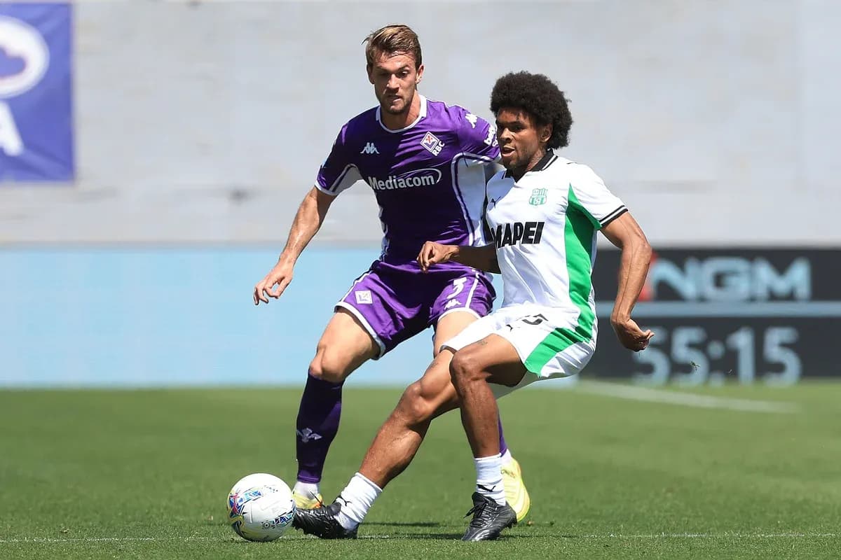 Fiorentina player challenges Sassuolo opponent for ball