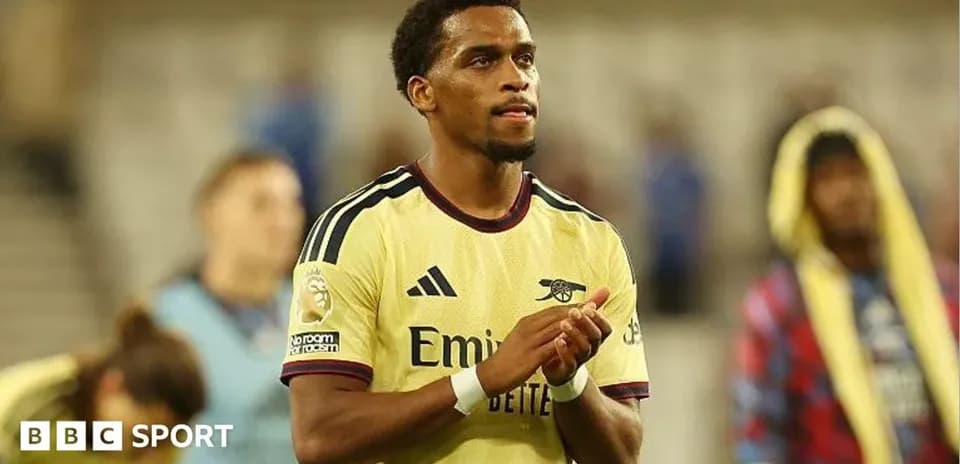 Player applauding fans after match in yellow kit