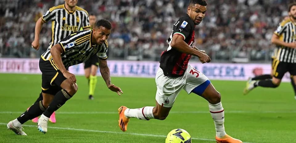 AC Milan player dribbling past Juventus defender