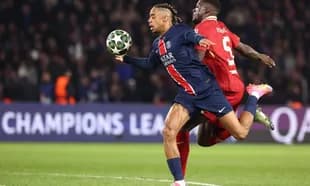 PSG player in action against Liverpool defender