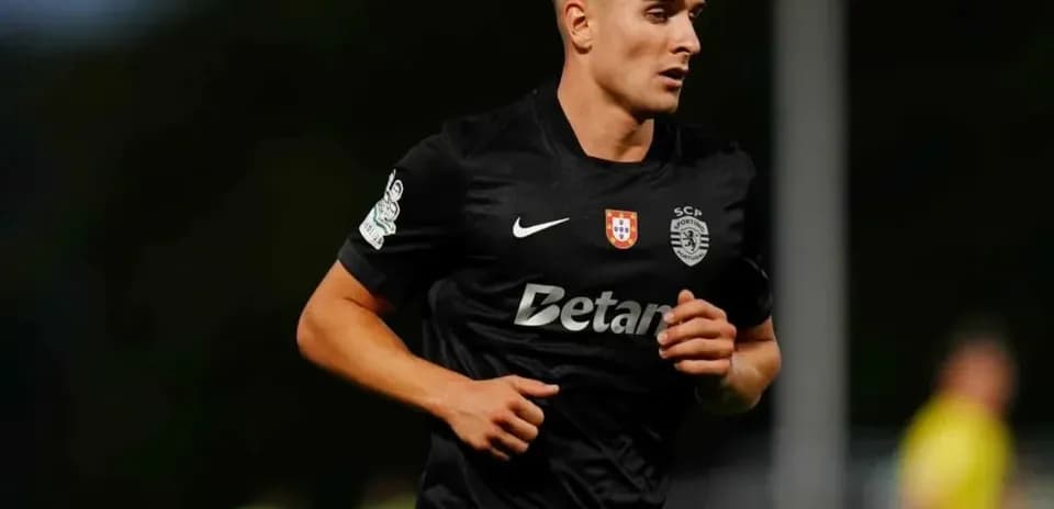 Player running during a football match wearing black kit