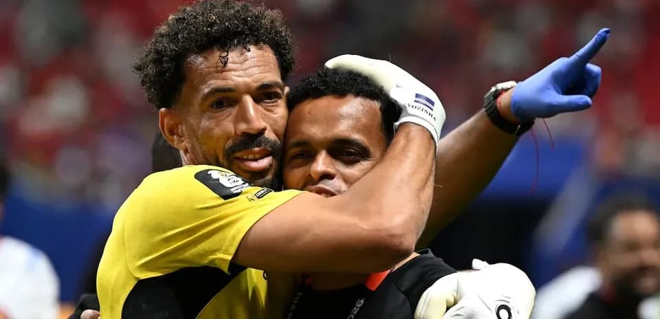 Goalkeeper and coach celebrating after a match