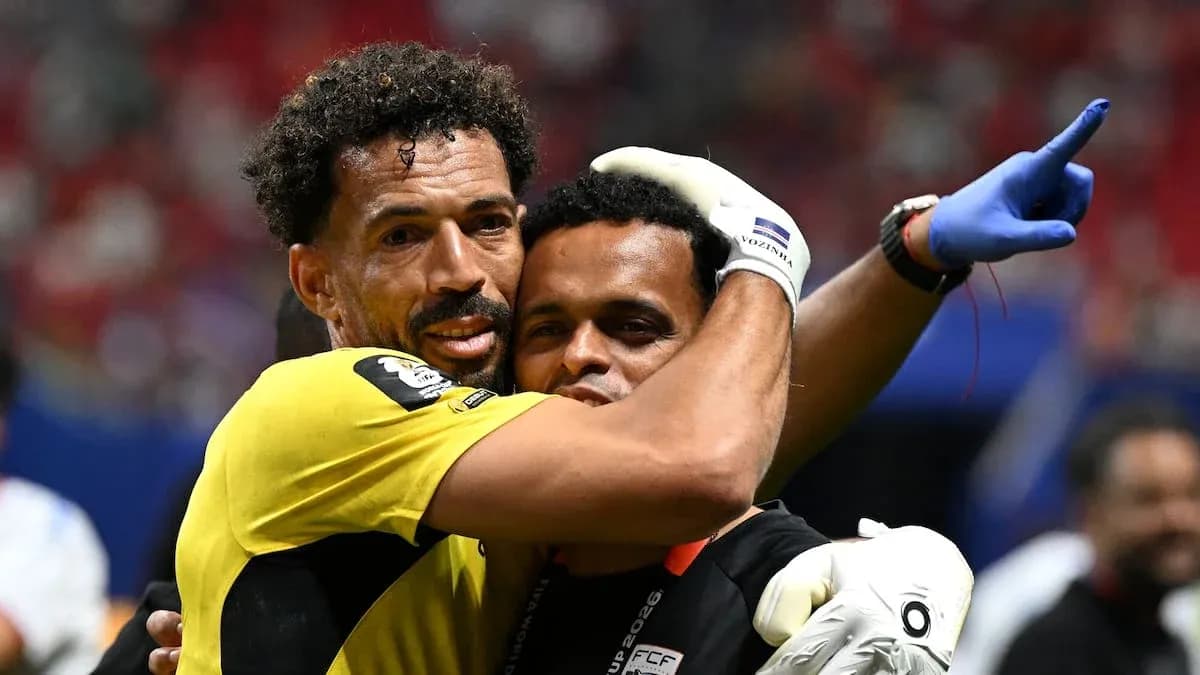 Goalkeeper and coach celebrating after a match