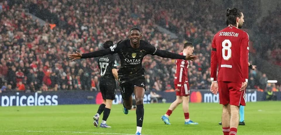 Player celebrating a goal during a rainy match