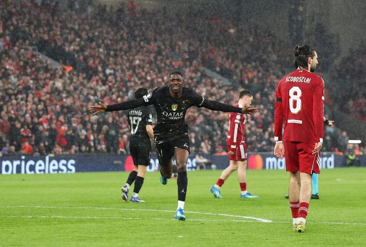 Player celebrating a goal during a rainy match