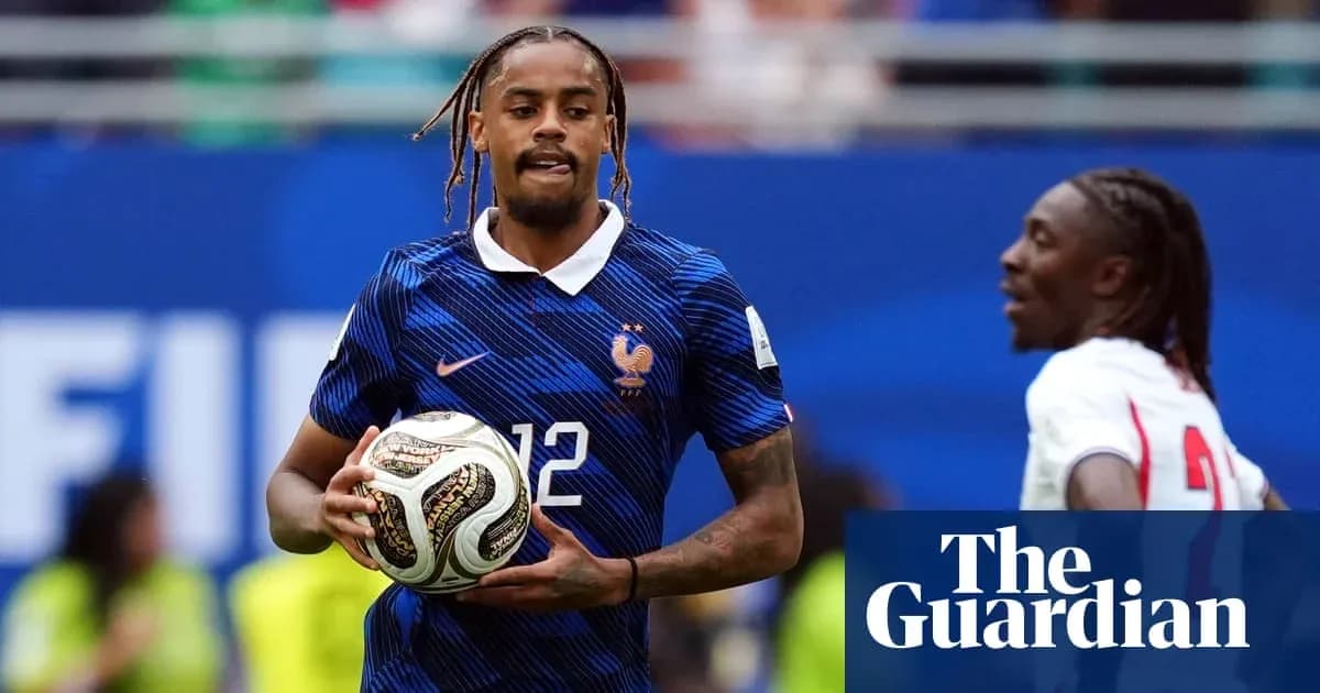 Player in France kit holding a soccer ball
