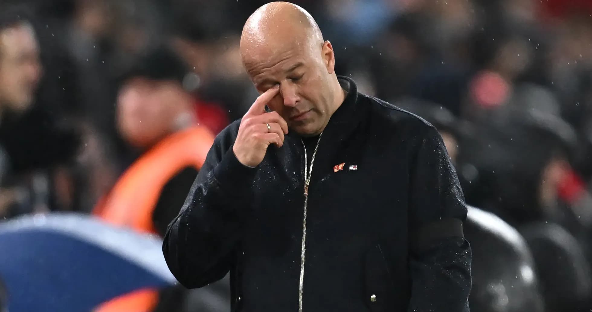 Coach wiping his eye during a match