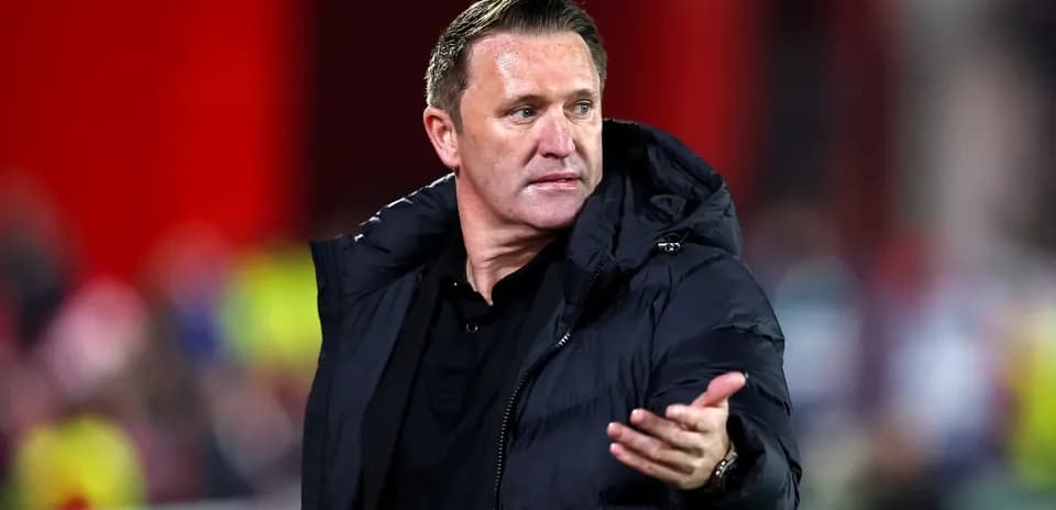 Coach gesturing during a match on the sidelines