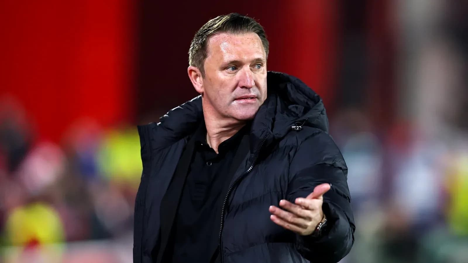 Coach gesturing during a match on the sidelines