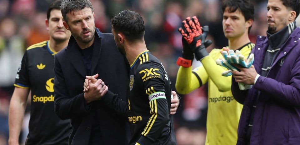 Manager and player shaking hands on the pitch