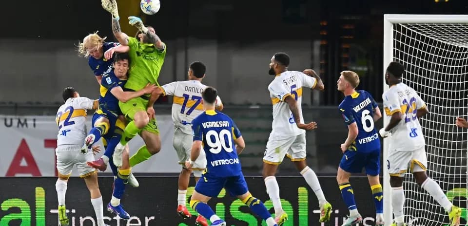 Goalkeeper attempting to catch the ball in match