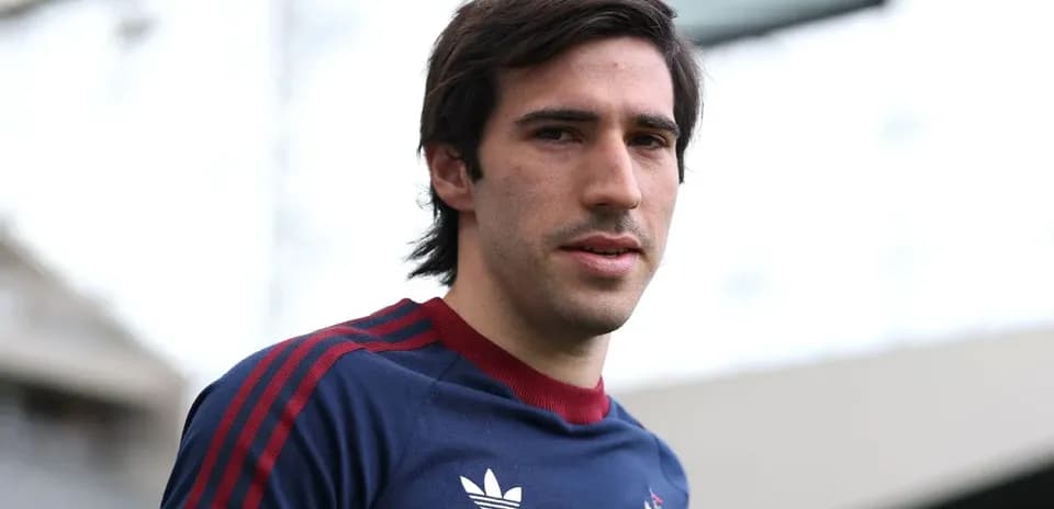 Football player posing in training kit outdoors