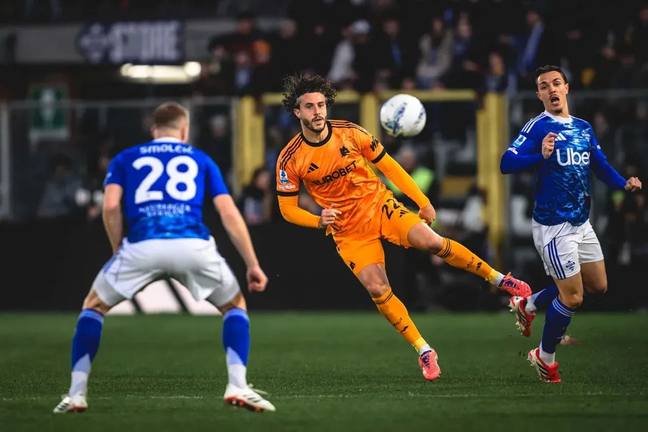 Player in orange jersey kicking the ball