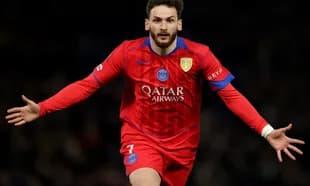 Player celebrating a goal in red PSG jersey