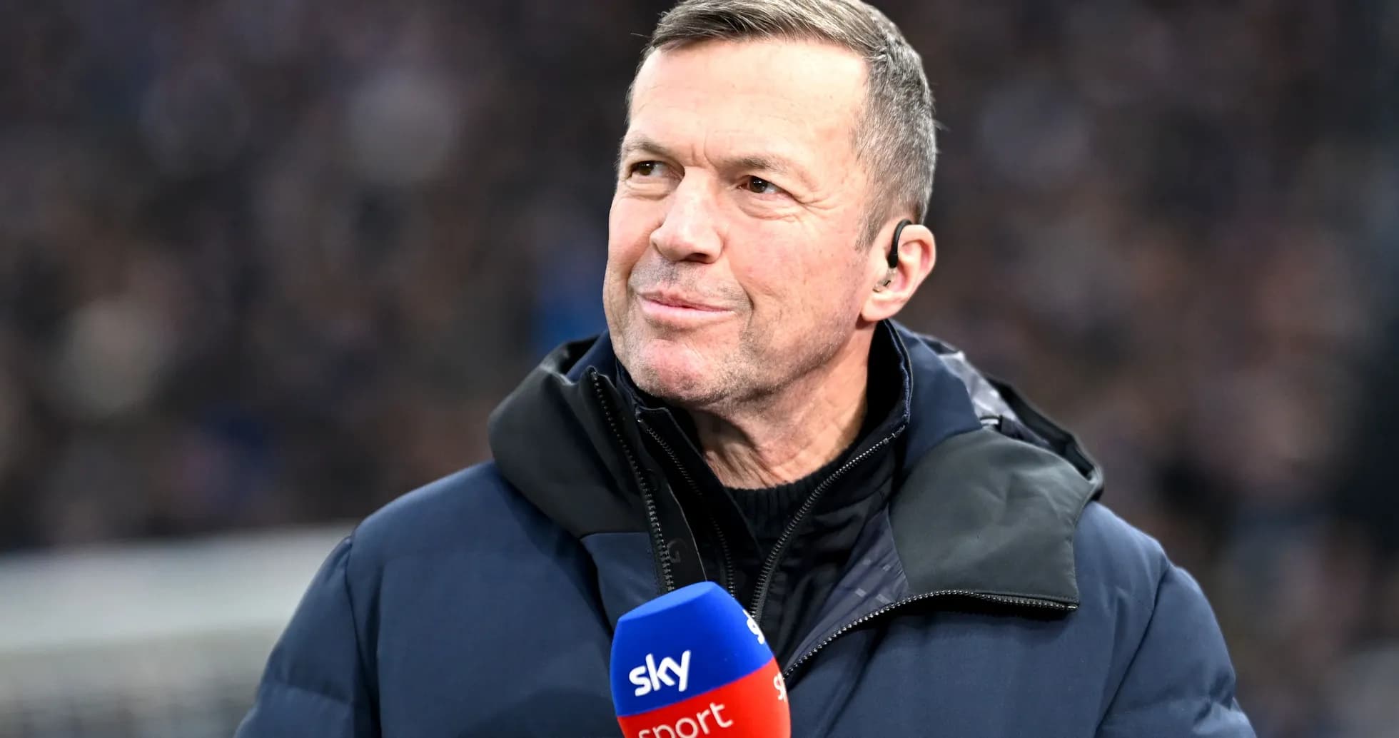 Sports commentator speaking into microphone on field