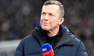 Sports commentator speaking into microphone on field