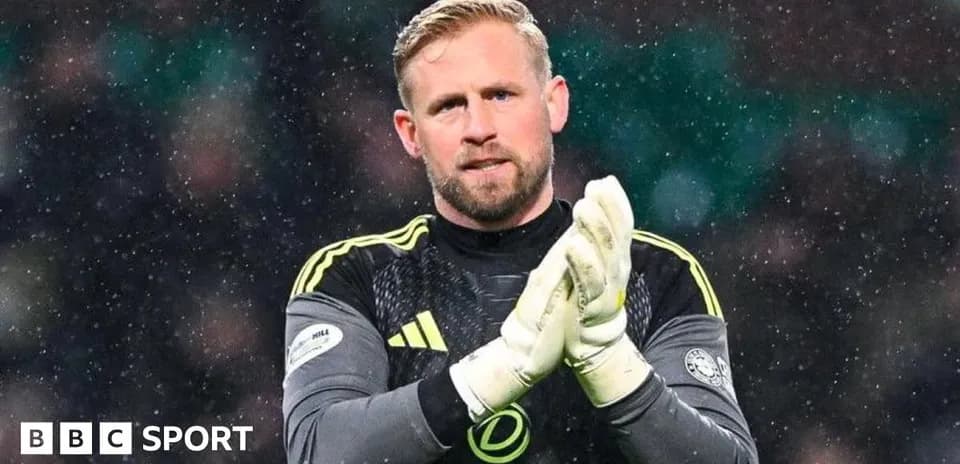 Goalkeeper clapping hands in snowy match