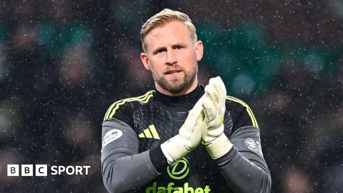 Goalkeeper clapping hands in snowy match