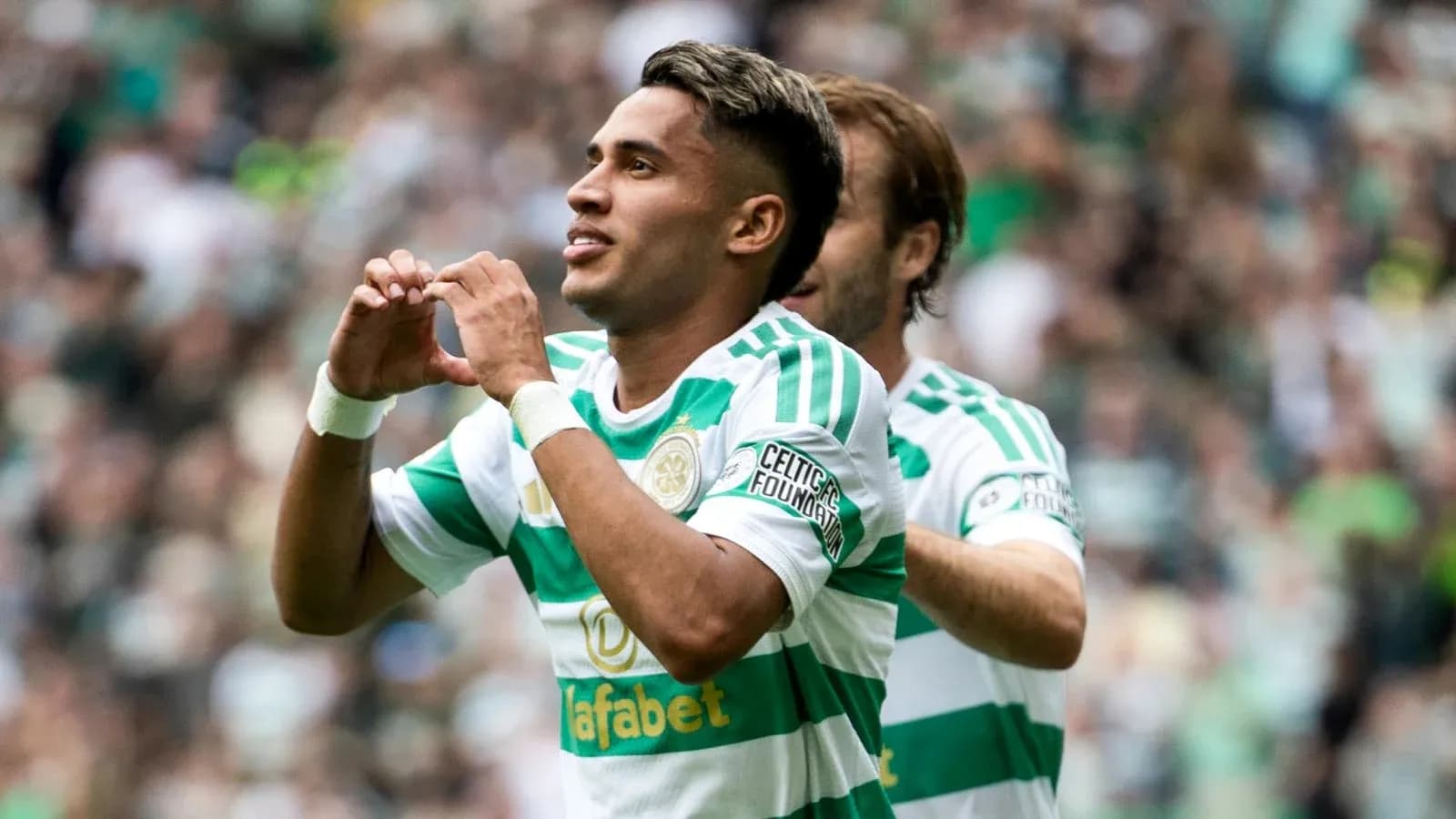 Player celebrating a goal with heart gesture